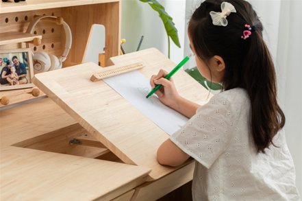 child drawing on a piece of paper