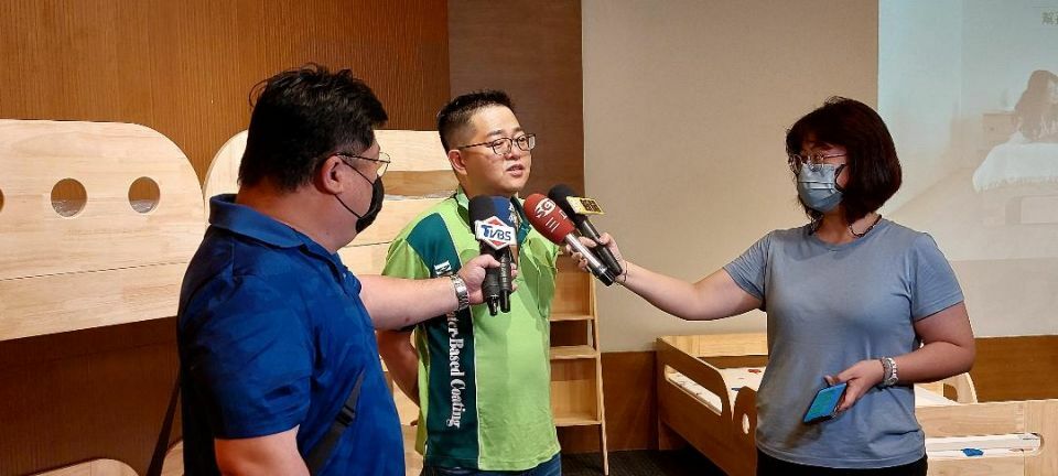 two reporters interviewing a man