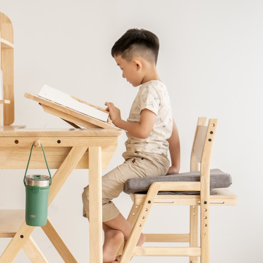 a boy using a study desk to read books